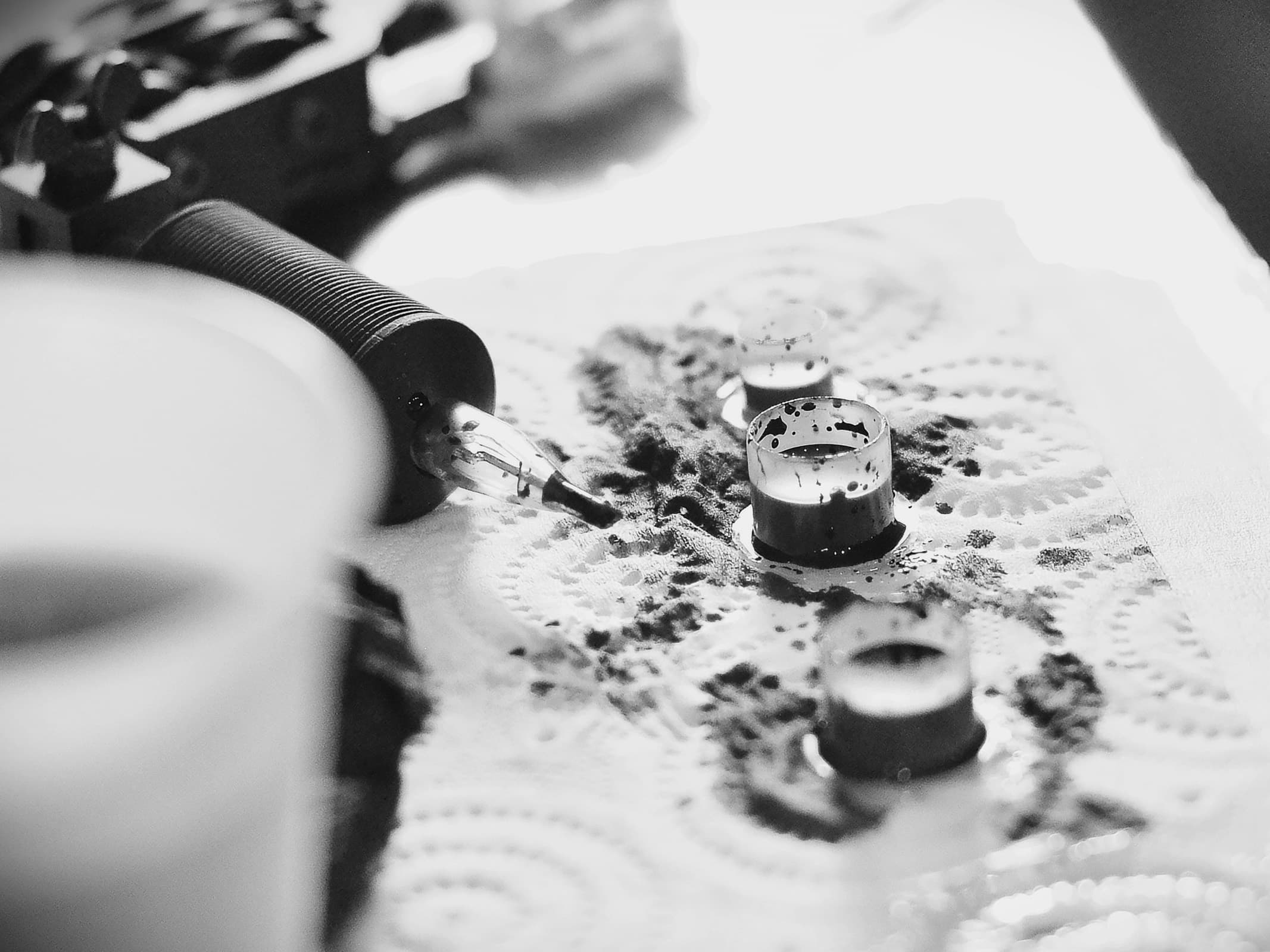 Tattoo artist working in a clear, organised studio environment